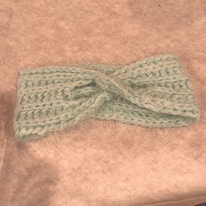 Knit poly blend headband in mint green with silver thread.